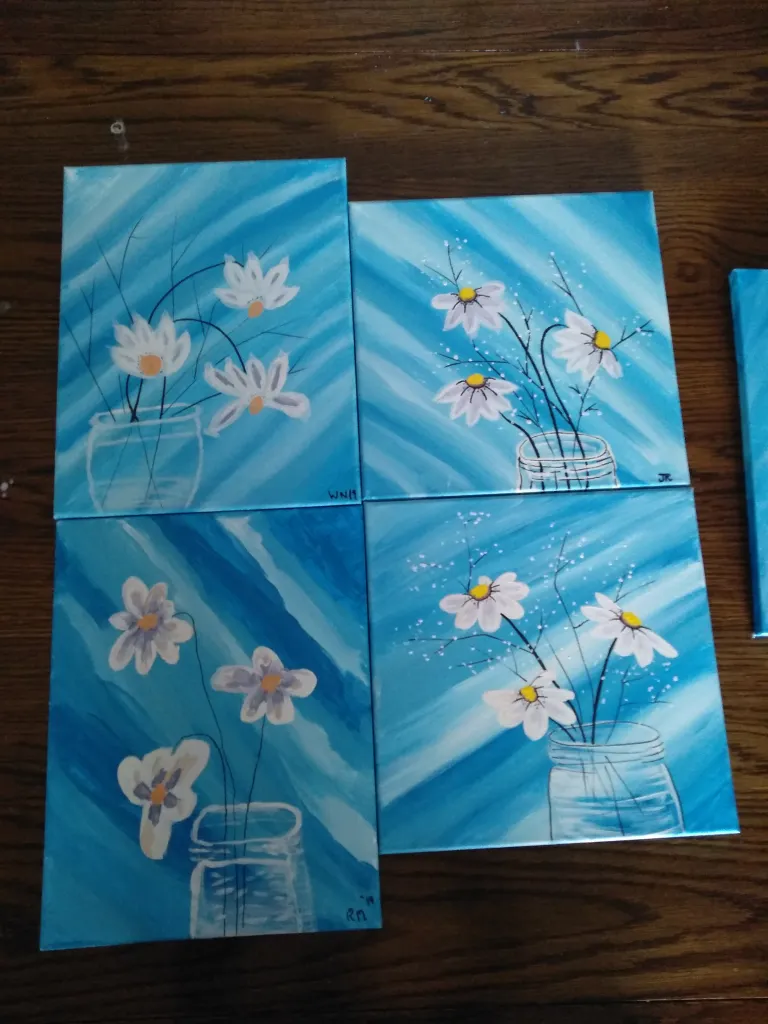 Blue floral canvases created during a painting event