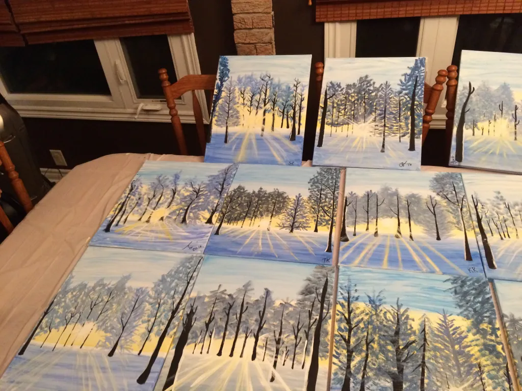 A collection of winter landscape canvases completed at a Creative Connie paint event