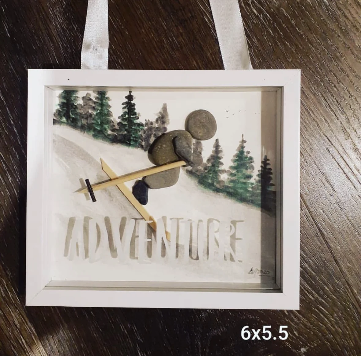 Ski adventure pebble art in a white frame