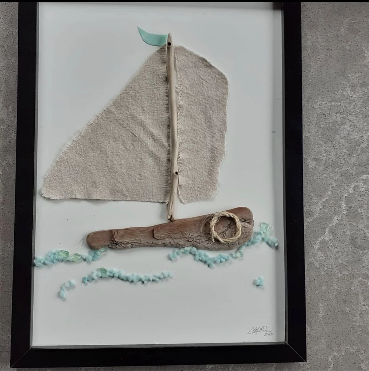 Sailboat pebble art made with driftwood and fabric