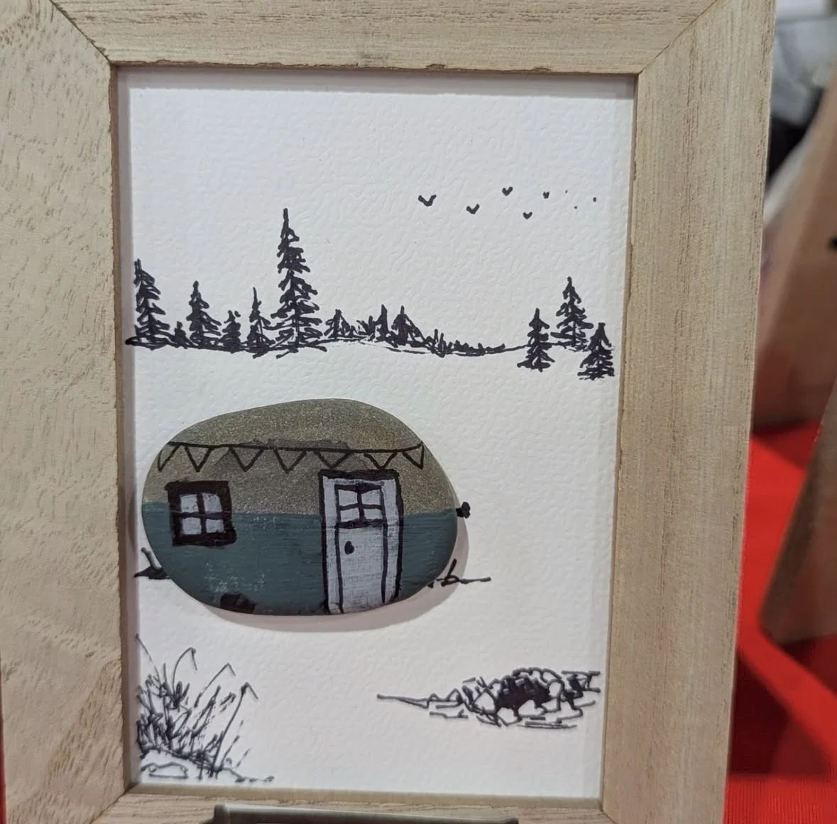 Camper themed pebble art framed with hand-drawn trees and birds