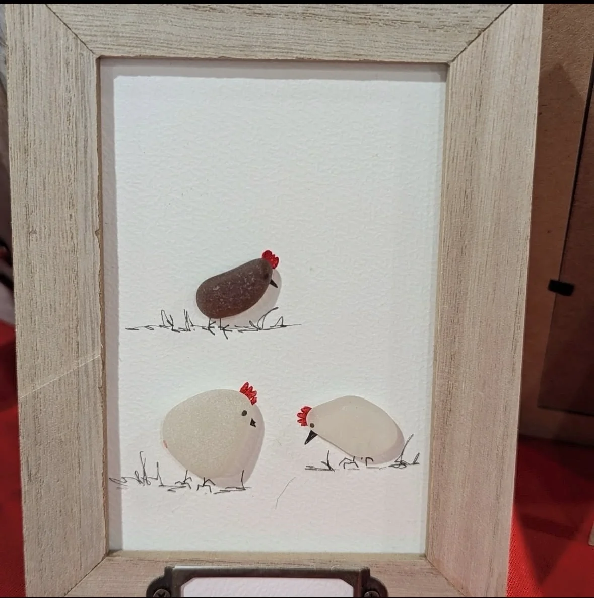 Chicken pebble art with hand-drawn details